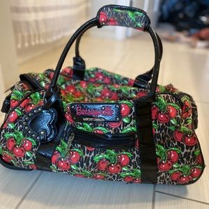 Betsey Johnson Rolling travel bag w/ pull handle.